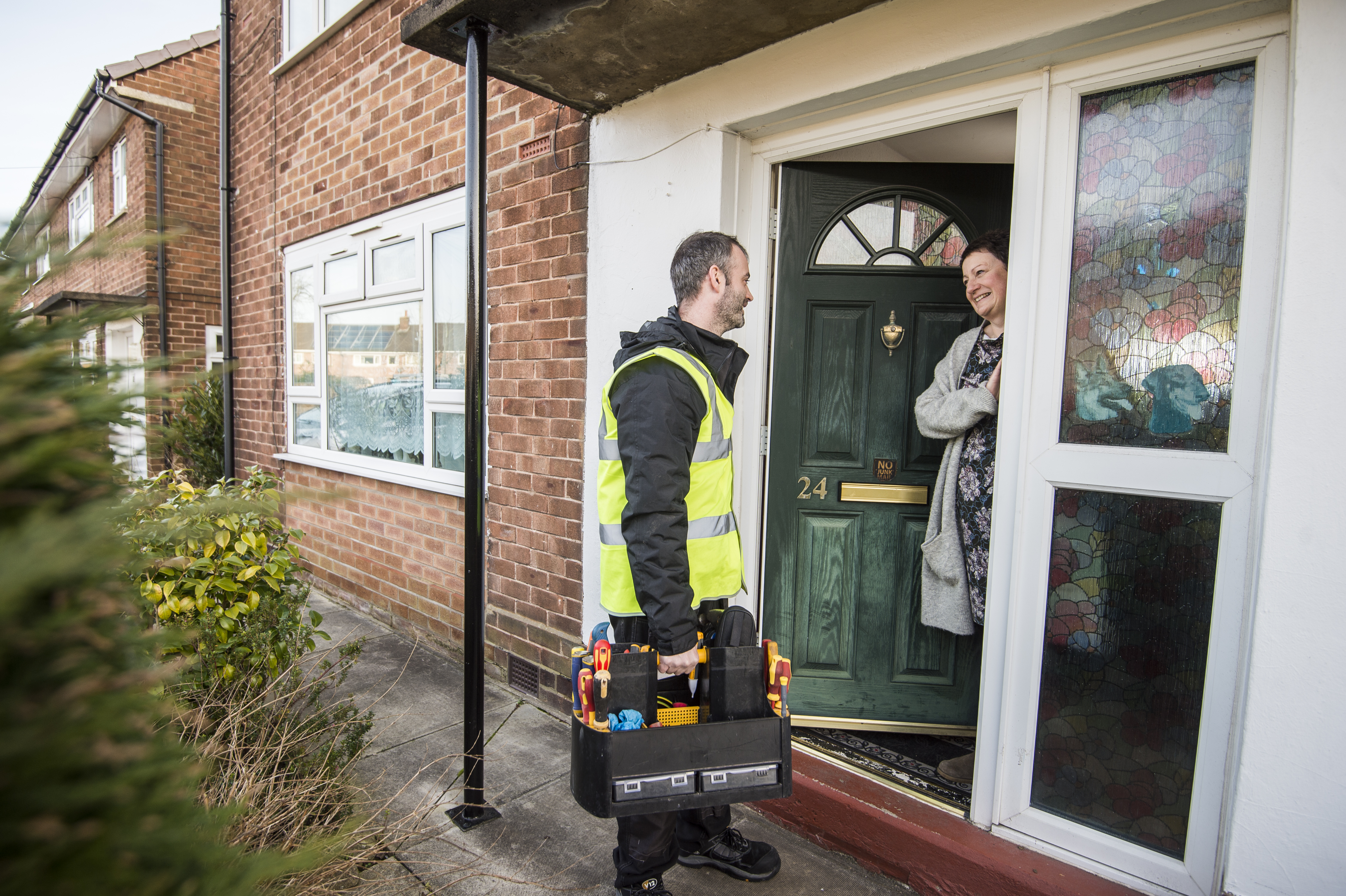 A member of our Repairs Team greets a customer at their door.